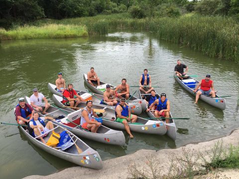 Camp Thunderbird alumni group shot in boats
