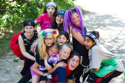 Girl campers and their counselor being silly at Camp Thunderbird