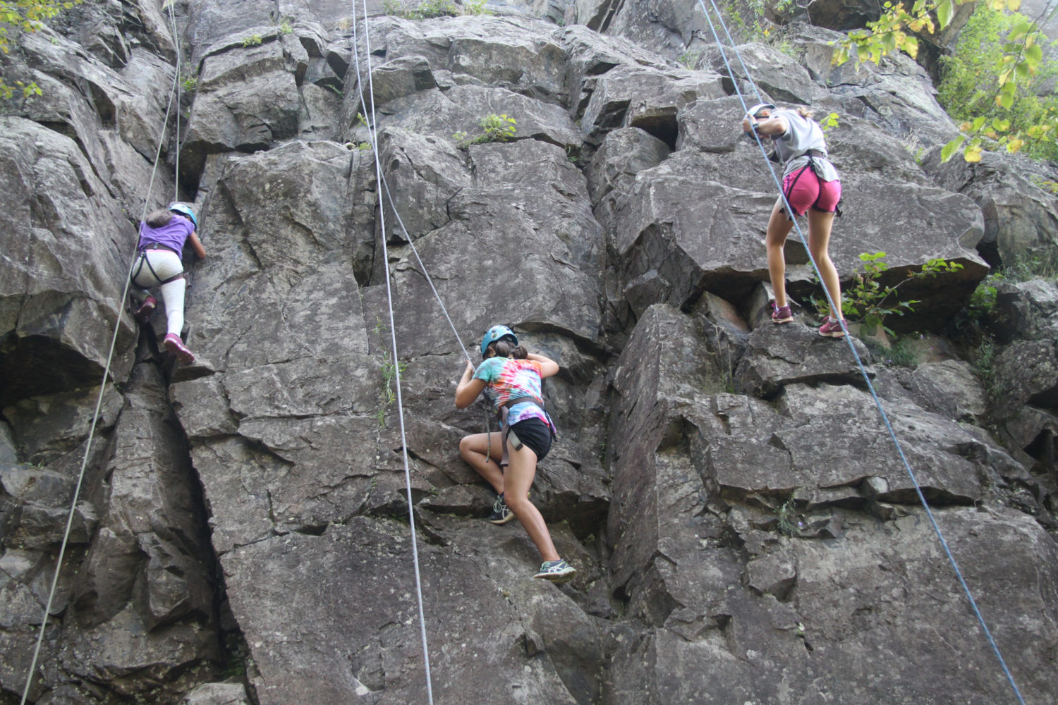 Camp Thunderbird kids climbing a rock face during adventure camp