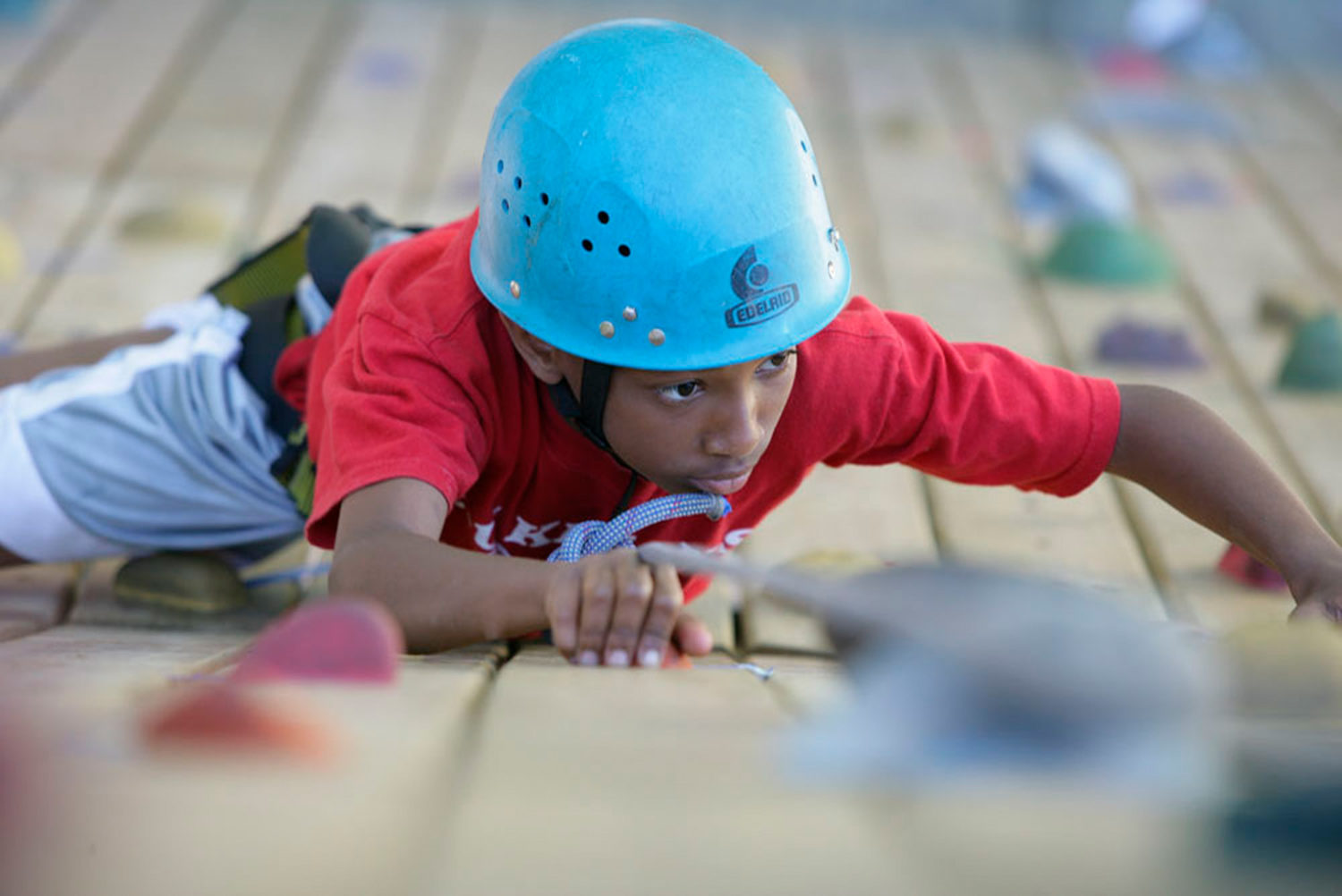 Boy climbing a rock wall