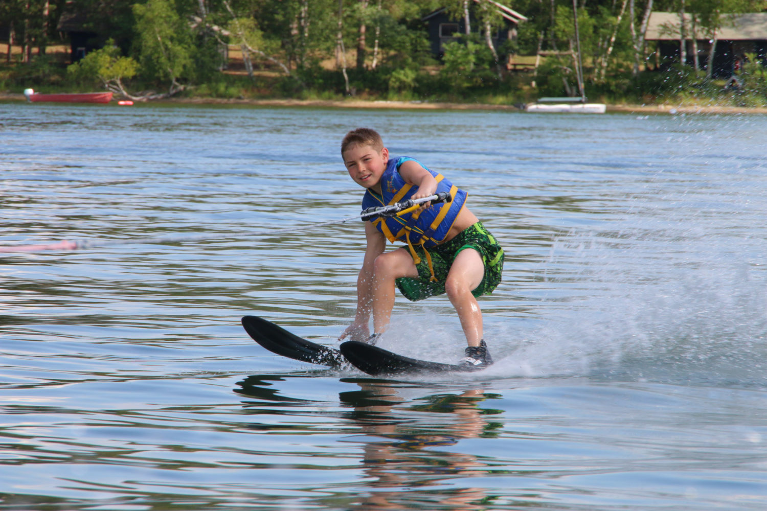 Boy water skiing on lake at Camp Thunderbird