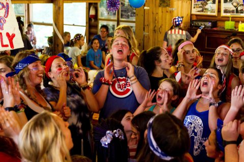 Counselor leading girls in song at Camp Thunderbird