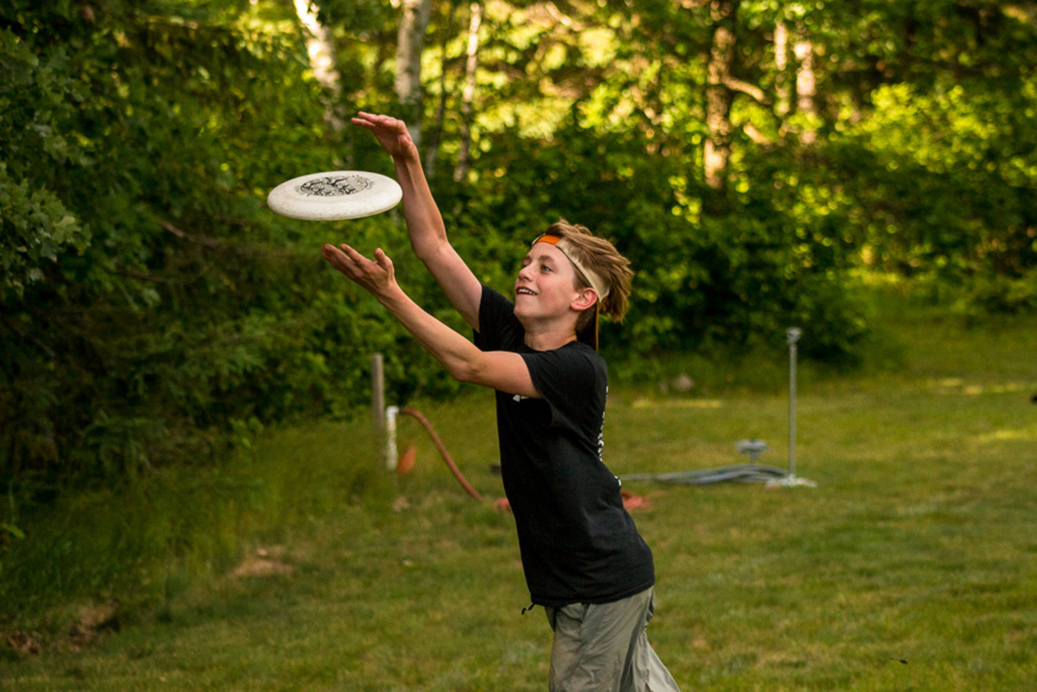 Boy at camp catching a Frisbee