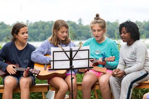 Girls singing during a summer camp activity