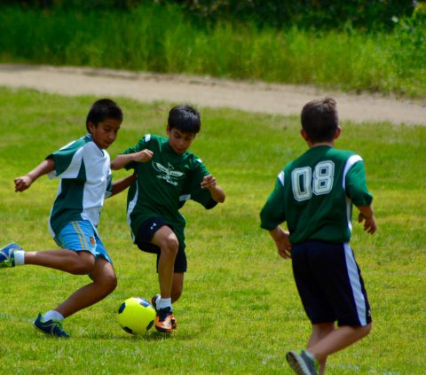 Boys playing soccer at boy's summer camp