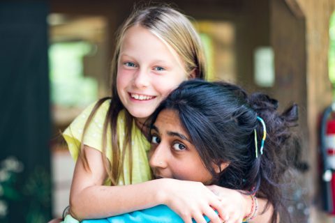 Camp Thunderbird girls councilor hugging a camper