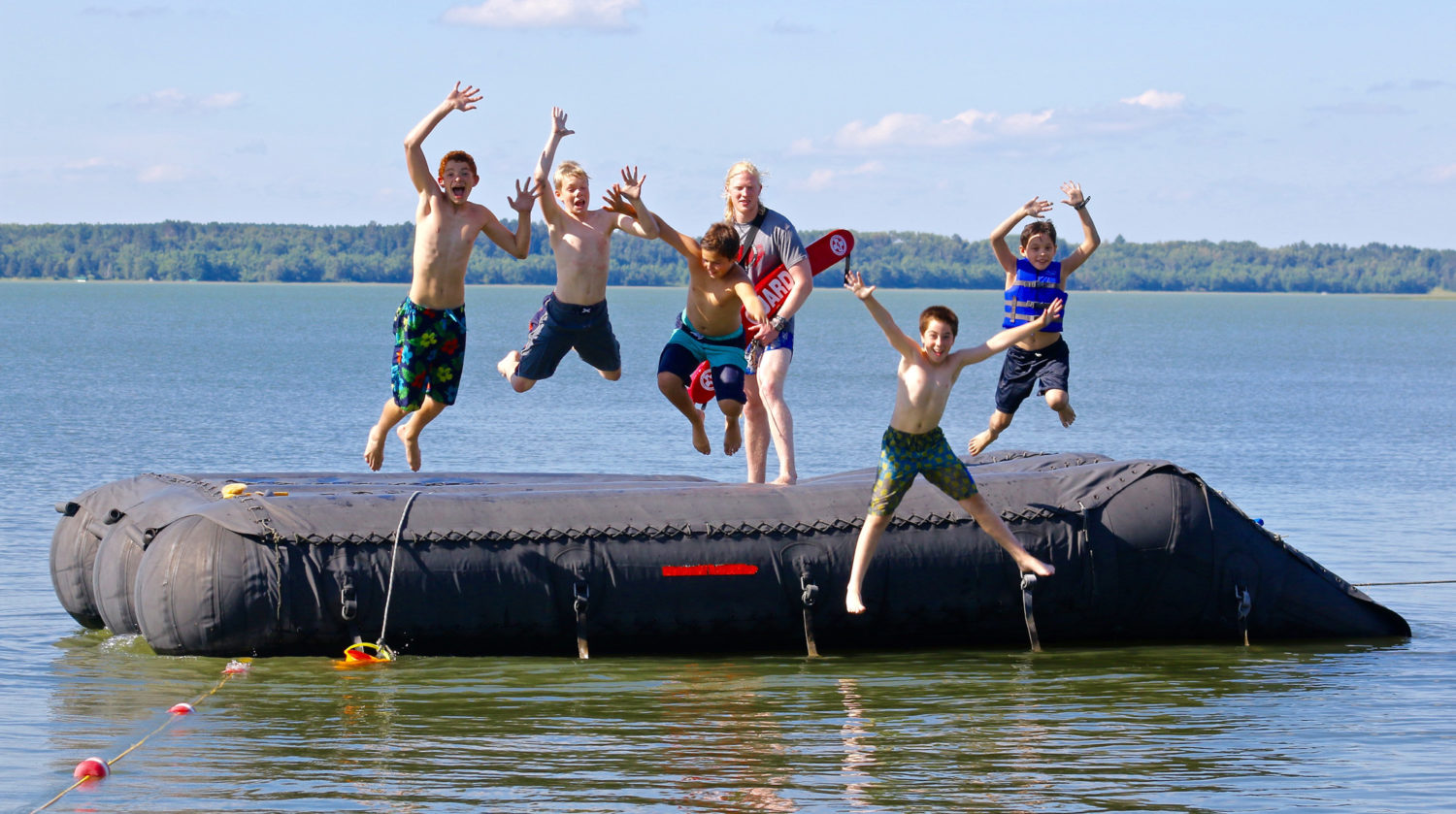 Kids jumping into the lake